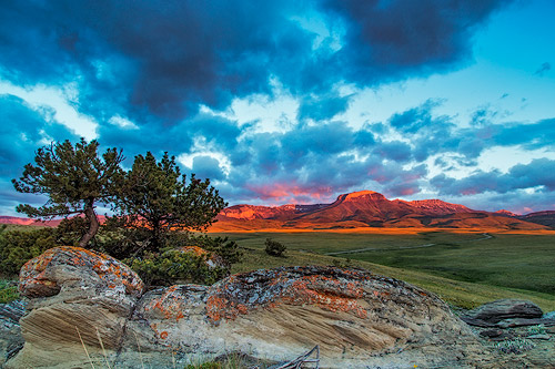 Fiery sunrise light strikes Ear Mountain along the Rocky Mountain Front near Choteau, Montana.